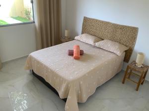a stuffed animal is sitting on a bed at Casa dos cajueiros in Paracuru