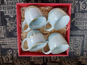 a red box filled with white nesting bowls at Ohessaare Windmill -Experience accommodation in Ohessaare +32 photos