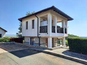 a large white house with a balcony at Villa Jasmin in Aheloy