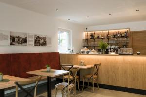 a restaurant with two tables and a bar at Villa Rosengarten Guesthouse in Merano