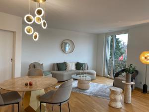 a living room with a table and a couch at New and elegant luxury apartment in Kloten