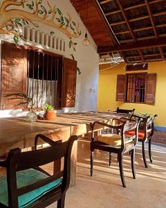 a dining room with a large wooden table and chairs at Dragon-Fly Home Hikka in Dodanduwa