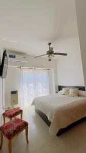 a bedroom with a bed and a ceiling fan at Mimi’s Dream Luján 2 in Luján