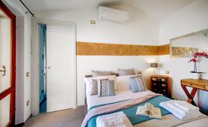 a bedroom with a bed with a book on it at Aquaemaris Apartment in La Maddalena