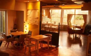a restaurant with tables and chairs and a kitchen at Hotel Ambiente in Dortmund +12 photos