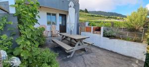 a picnic table and an umbrella on a patio at Lar da Rita - One bedroom apartment in Água Retorta