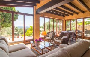 a living room with couches and tables and windows at S'alzinar Gran in Artá +33 photos