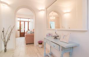 a living room with a blue table and a mirror at Convent in Alcudia