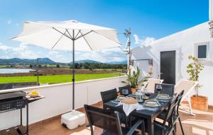 a patio with a table and an umbrella at Sa Fornera in Alcudia