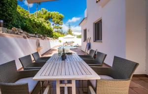 a wooden table and chairs on a patio at Mar Bella Nou in Font de Sa Cala