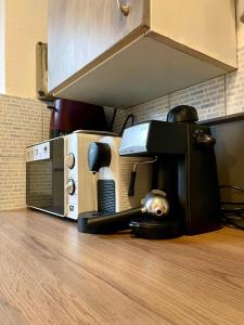 a microwave sitting on top of a kitchen counter at Ov152 Apartman in Budapest