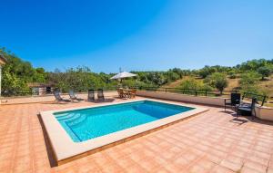 a swimming pool on top of a house with a patio at Can Baldo in Sencelles