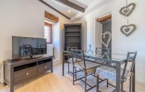 a dining room with a glass table and a tv at Can Roses in Moscari +24 photos