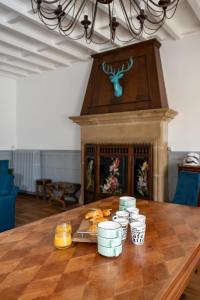 a table with a fireplace with a tray of food at L'Escale du Rhône de 1 à 8 personnes in Saint-Vallier +38 photos