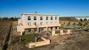 an aerial view of a large white building with a pool at Hotel Finca Alvear in General Alvear