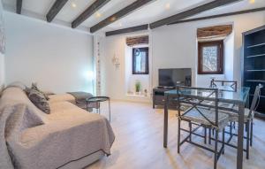 a living room with a couch and a glass table at Can Roses in Moscari