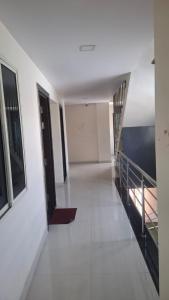 an empty hallway with stairs in a building at JJ Comfort Hotel in Turuvekere