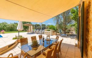 a patio with a table and chairs and an umbrella at Kiana in Santa Eugenia