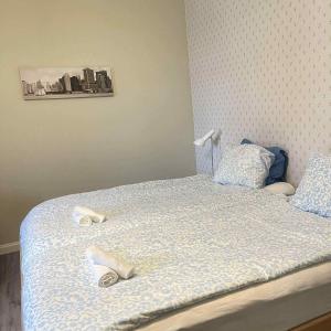 a bedroom with a bed with shoes on it at Nymans pensionat in Aneby