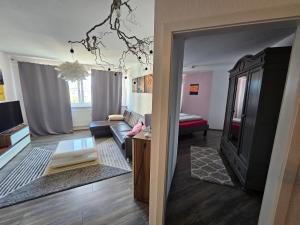 a living room with a couch and a table at Deluxapartment in Kaiserslautern