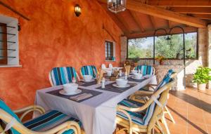 a dining room with a long table and chairs at Ca Na Conceda in Alcudia