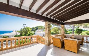 a balcony with chairs and a view of the ocean at Mar Bella Nou in Font de Sa Cala +29 photos
