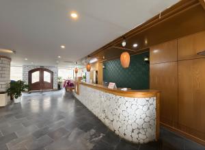 a restaurant with a counter and a lobby at Cloud Chaser Hotel in Sapa