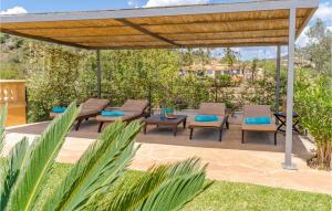 a patio with chairs and a wooden pergola at Es Socorrat in Portocolom +34 photos