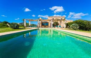 a swimming pool in front of a villa at Can Carrio in Son Servera