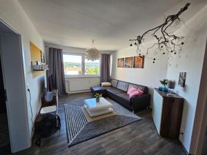a living room with a couch and a table at Deluxapartment in Kaiserslautern