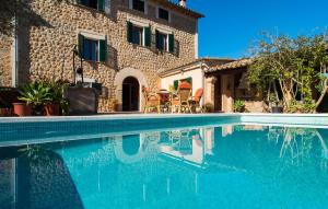 a swimming pool in front of a house at Frontera in Sóller