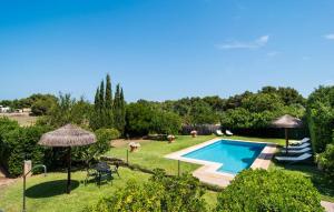 a swimming pool in a yard with umbrellas at Can Polito in Can Picafort +39 photos