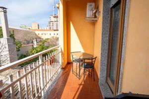 a balcony with a table and chairs on it at Casa Wanda IL MIRTO in Oristano
