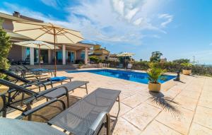 a patio with chairs and an umbrella next to a pool at Redrema in Llucmajor +44 photos