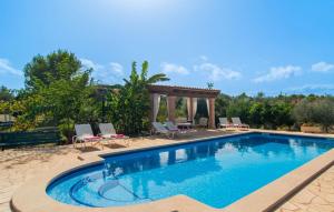a swimming pool with chairs and a gazebo at Sa Plana Port Nou in Cala Millor +34 photos