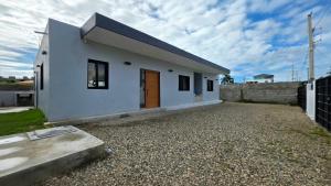 a white house with a gravel driveway at Ivy Villa Cabarete, fully equipped villa in Cabarete