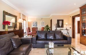 a living room with a leather couch and a mirror at Montelago in Alcudia