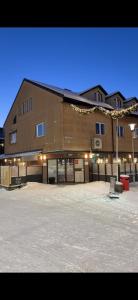 a large building with a parking lot in front of it at Kirkenes down town apartments in Kirkenes