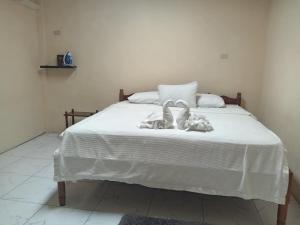 a bed with two towels on top of it at D Grand Charlton in Cattle Landing