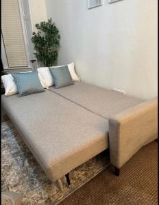 a bed with two pillows on it in a room at Stylish Glasgow Apartment in Whiteinch