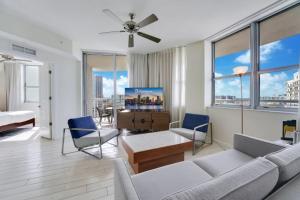 a living room with a couch and chairs and windows at Circ Hotel in Hollywood