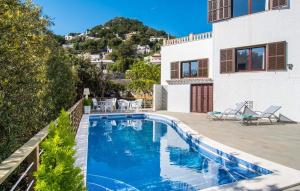a swimming pool in front of a house at Corazon in Canyamel