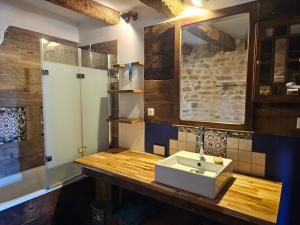 a bathroom with a sink on a wooden counter at Ferme écologique in Saint-Junien-les-Combes +31 photos