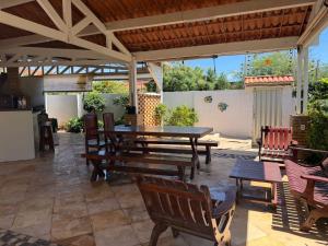 a patio with wooden tables and chairs and a table at Casa Beach park in Aquiraz