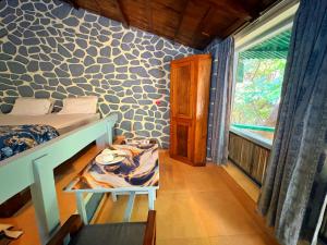 a bedroom with a bed and a window in a room at Captans Stay in Lonavala