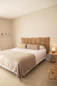 a bedroom with a large bed and a table at Casa Bora Hotel Boutique in San Antonio de Areco