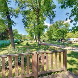 a wooden fence in a park with trees at ZEcamping 3 étoiles aire de jeux multi-activités in Toulouse