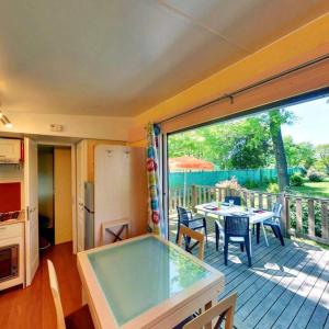 a room with a pool table on a deck with a view at ZEcamping 3 étoiles aire de jeux multi-activités in Toulouse +14 photos