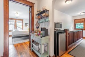 a kitchen with a desk and a tv in a room at Boscobel Bungalow in Nashville