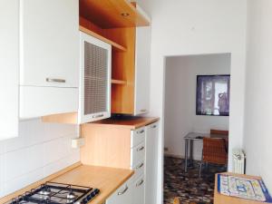 a kitchen with white cabinets and a stove at Il Cedro Argentato in Monza